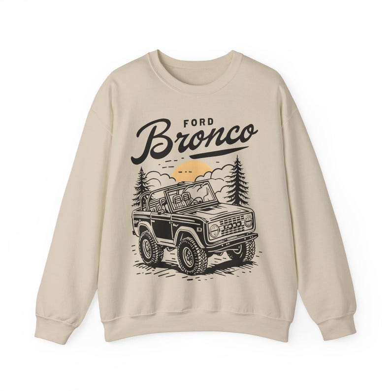 The Ford Bronco Adventure Sweatshirt exudes a sense of adventure and ruggedness, perfect for outdoor enthusiasts and fans of the iconic vehicle. This cozy sweatshirt is made with a medium-heavy fabric blend of 50% cotton and 50% polyester, providing