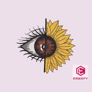 Puede incluir: Un diseño de bordado estilizado que presenta un ojo humano con pestañas y un girasol. El ojo y el girasol están divididos por la mitad, con el ojo a la izquierda y el girasol a la derecha. El diseño está en negro, marrón, blanco y amarillo.