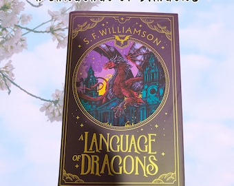 May include: A hardcover book titled "A Language of Dragons" with a purple cover. The cover features a red dragon illustration over a building, with the author's name, S.F. Williamson, at the top. The title is in gold lettering.