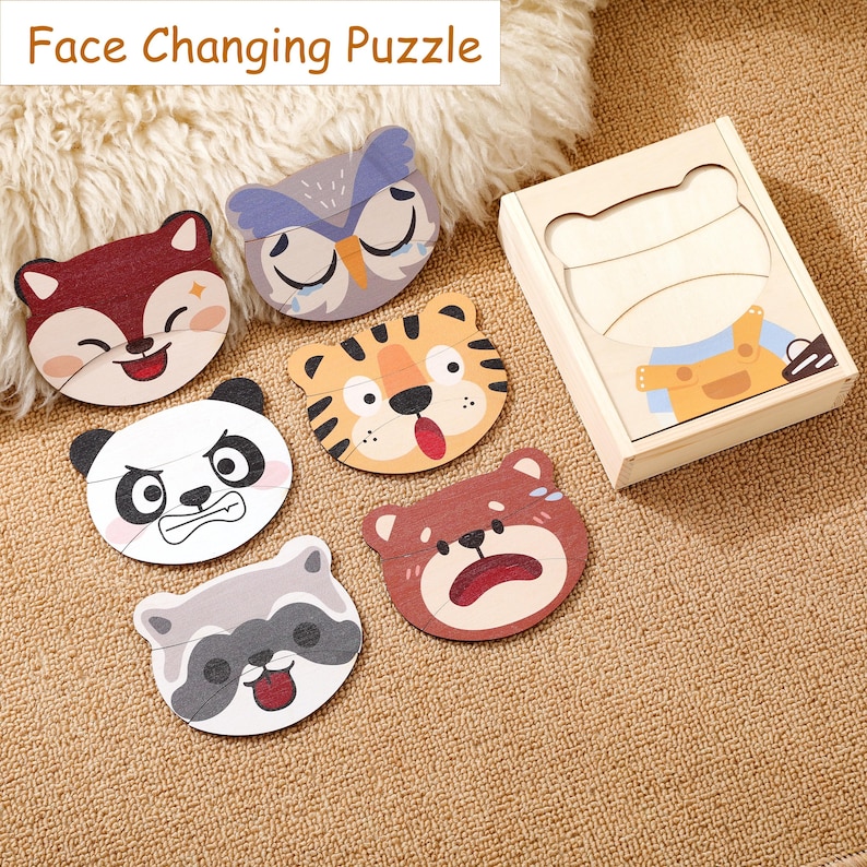 K&ouml;nnte beinhalten: Holz-Gesichtswechsel-Puzzle mit sechs Tiergesichtern: Fuchs, Eule, Tiger, Panda, B&auml;r und Waschb&auml;r. Jedes Tiergesicht hat zwei Ausdr&uuml;cke. Das Set enth&auml;lt eine Holzkiste mit einem B&auml;ren-Design. Der Text "Face Changing Puzzle" steht oben.