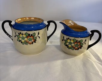 This is a vintage Noritake hand-painted lusterware creamer and sugar set.