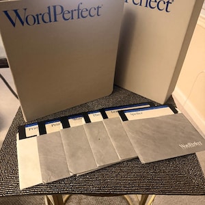 May include: A beige WordPerfect software binder and matching box set, accompanied by a row of five gray 3.5-inch floppy disks. Each disk features a white label with blue text, including titles like Speller and Printer, and the WordPerfect Corporation logo.