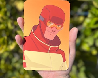 May include: A close-up of a superhero illustration. The character is wearing a red and yellow suit with a red helmet and yellow goggles. The background is a gradient of orange and yellow.