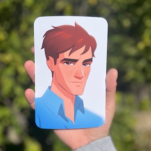 May include: A rectangular card featuring a stylized illustration of a man with auburn hair and a blue shirt. The illustration has a clean, modern aesthetic with a focus on the man's facial features.