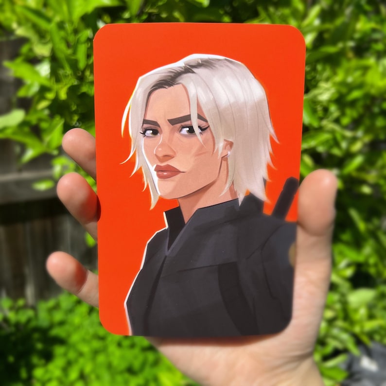 May include: A portrait of a person with short white hair, wearing a black shirt, against a red background.