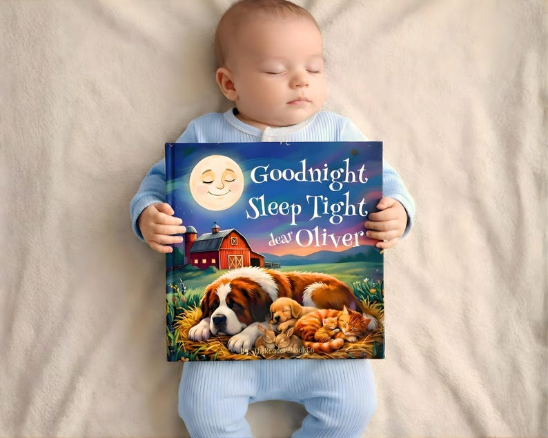 May include: A sleeping baby in blue pajamas holds a children's book titled "Goodnight Sleep Tight dear Oliver." The book cover features a full moon, a red barn, and a dog with puppies and kittens.