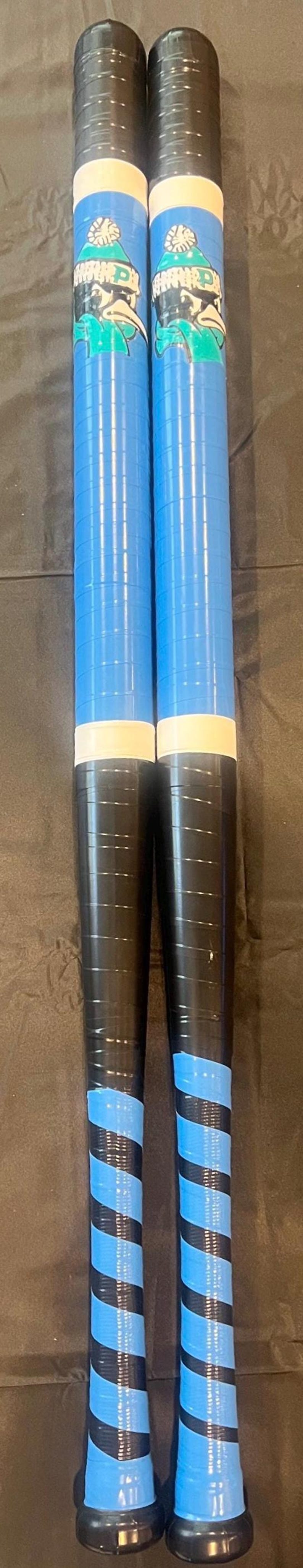 May include: Two cylindrical objects, likely sports equipment, are shown. They are primarily blue and black, with a white band and a cartoon character on the top. The bottom has blue and black stripes.