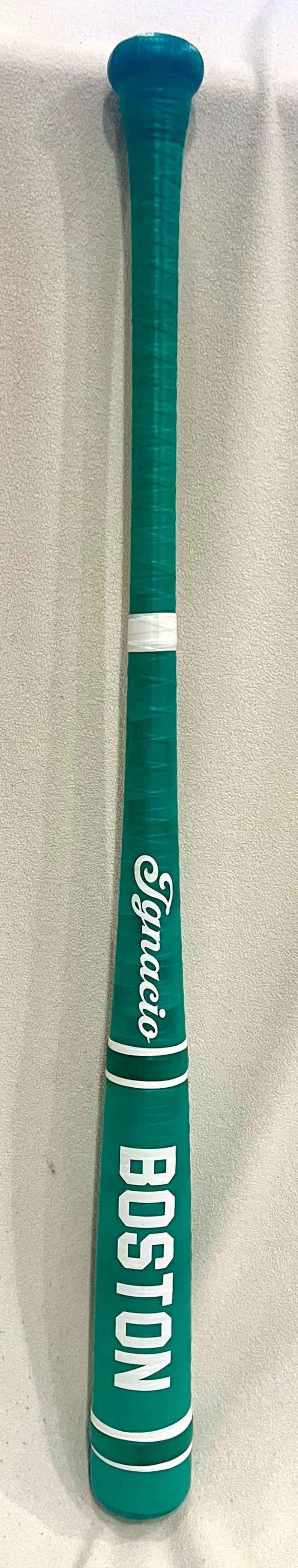 May include: A teal baseball bat with white accents and the name "Ignacio" in white script. The word "BOSTON" is printed in white block letters near the base of the bat.