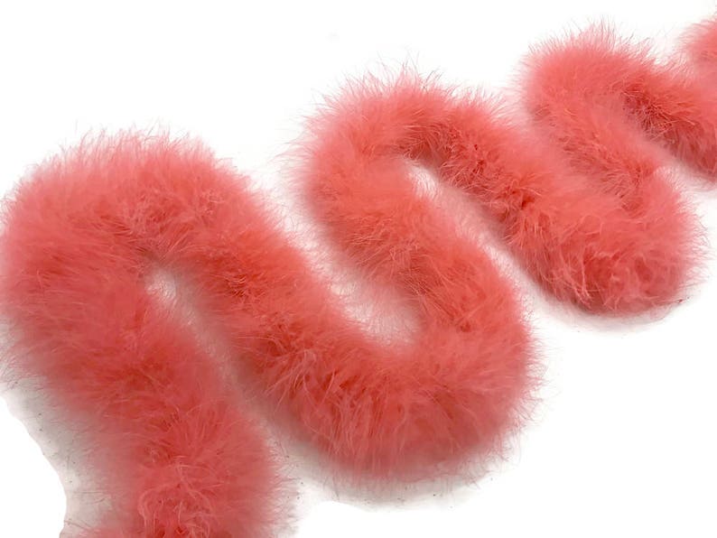 May include: A long strand of pink feather boa. The boa is soft and fluffy, and it is perfect for adding a touch of glamour to any outfit.