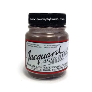May include: A glass jar of Jacquard Acid Dye in the color 616 Russet. The label reads "Jacquard Acid Dyes 616 Russet Bright, Lightfast, Washefast Colors for Silk, Wool, Feathers, Nylon".
