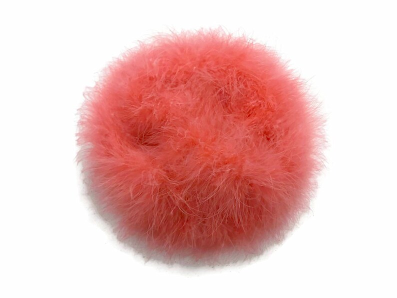 May include: A fluffy, round, pink feather boa. The boa is soft and delicate, and would be perfect for adding a touch of whimsy to any project.