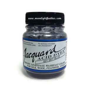 May include: A glass jar of Jacquard Acid Dyes in Sky Blue 621. The jar has a black lid and a white label with blue accents. The label includes the text "BRIGHT, LIGHTFAST, WASHFAST COLORS FOR SILK, WOOL, FEATHERS, NYLON."
