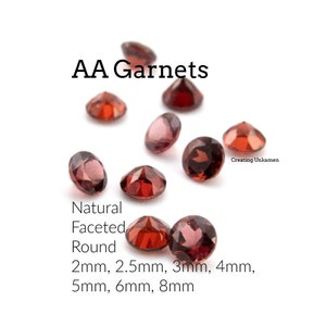 May include: A collection of natural, faceted, round garnet gemstones in various sizes, ranging from 2mm to 8mm. The garnets are a deep red color and are arranged on a white background.