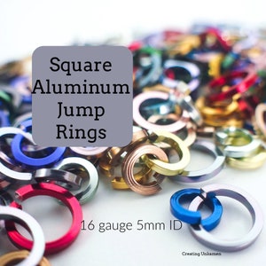 May include: A close-up of a pile of colorful square aluminum jump rings. The rings are 16 gauge and have a 5mm inner diameter.  Square Aluminum Jump Rings.