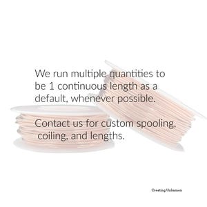 May include: Two white plastic spools wound with thin, light pink cord. The text reads: We run multiple quantities to be 1 continuous length as a default, whenever possible. Contact us for custom spooling, coiling, and lengths. Creating Unkamen.