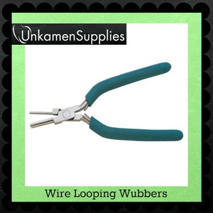 May include: Teal handled wire looping pliers for jewelry making. The pliers are made of metal with a silver finish. The handles are covered in a teal rubberized material. The text "Wire Looping Wubbers" is printed below the image.