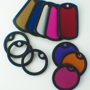 May include: Assortment of blank, round and rectangular dog tags in various colors, including red, purple, orange, pink, blue, white, and brown. The tags are made of a durable material and have a black border.