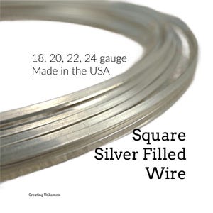 May include: A coil of square silver-filled wire with a metallic finish. The text on the image reads: 18, 20, 22, 24 gauge, Made in the USA, Square Silver Filled Wire, and Creating Unkamen. The wire is arranged in a circular loop.