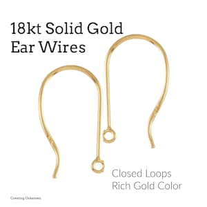 May include: Two 18kt solid gold ear wires with closed loops in a rich gold color. The ear wires are curved with a small loop at the bottom and a small decorative detail on the curve. Text on the image reads "18kt Solid Gold Ear Wires".