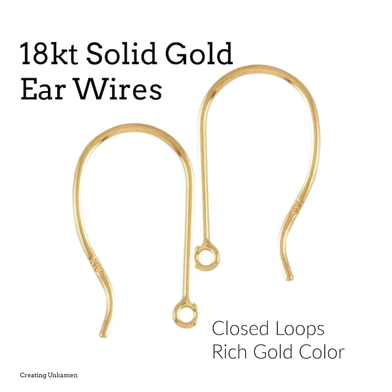 May include: Two 18kt solid gold ear wires with closed loops in a rich gold color. The ear wires are curved with a small loop at the bottom and a small decorative detail on the curve. Text on the image reads "18kt Solid Gold Ear Wires".