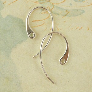 May include: Two silver earring hooks with a small loop at the top and a larger loop at the bottom.
