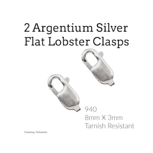 May include: Two silver-colored flat lobster clasps made of Argentium silver. The text reads 2 Argentium Silver Flat Lobster Clasps, 940, 8mm X 3mm, Tarnish Resistant, and Creating Unkamen. These jewelry findings feature a spring-loaded mechanism.