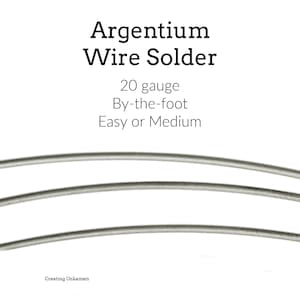 May include: Close-up of Argentium wire solder, 20 gauge, sold by the foot. The image shows several strands of silver-coloured wire against a white background. Text on the image reads "Easy or Medium."