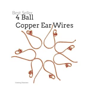 May include: A set of six copper ear wires with a small ball at the end of each wire. The wires are arranged in a star shape. The text "Best Seller 4 Ball Copper Ear Wires" is visible at the top of the image.