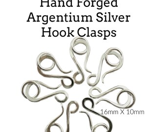 May include: Six hand forged tarnish resistant Argentium silver hook clasps arranged in a circular pattern. Each individual silver hook clasp measures 16mm x 10mm. The text Tarnish Resistant Hand Forged Argentium Silver Hook Clasps is visible.