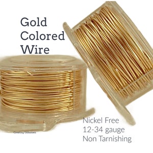 May include: Two spools of gold colored wire, one on top of the other. The wire is in a clear plastic container. The text on the label reads "Nickel Free 12-34 gauge Non Tarnishing".