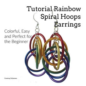 Könnte beinhalten: Regenbogenfarbene Spiral-Hoop-Ohrringe. Die Ringe sind ineinander verschlungen und hängen an silbernen Ohrhaken.