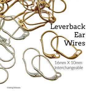 May include: A close-up of a pile of gold and silver leverback ear wires. The wires are 16mm x 10mm and interchangeable. The text "Leverback Ear Wires 16mm x 10mm Interchangeable" is visible in the image.
