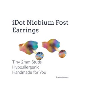 May include: iDot Niobium Post Earrings. Tiny 2mm Studs Hypoallergenic Handmade for You. Two small, iridescent, multi-coloured stud earrings with a metallic finish and post backs, displayed against a plain white background with black text.