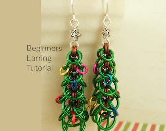 May include: A pair of chainmaille earrings shaped like Christmas trees, featuring green, red, blue, and yellow jump rings with silver star charms and hooks. The text O Christmas Tree Beginners Earring Tutorial Creating Unkamen is visible.
