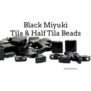 May include: A pile of black Miyuki Tila and Half Tila beads. The beads are small and have a shiny finish.
