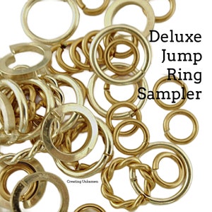 May include: A collection of gold jump rings in various sizes and styles. The jump rings are arranged in a pile and are ready to be used for jewelry making.
