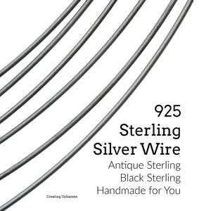 May include: Five curved strands of dark gray 925 sterling silver wire arranged in a fan pattern. The text on the image reads 925 Sterling Silver Wire, Antique Sterling, Black Sterling, Handmade for You, and Creating Unkamen.