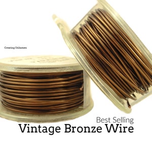 Pode incluir: Dois rolos de fio de bronze vintage, cada um em um recipiente de plástico transparente. O fio é enrolado firmemente ao redor do rolo. Os rolos são empilhados um em cima do outro. O texto "Best Selling Vintage Bronze Wire" é impresso abaixo dos rolos.