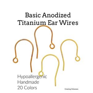 May include: Four curved, U-shaped anodized titanium ear wires in shades of bronze and gold. The text reads: Basic Anodized Titanium Ear Wires, Hypoallergenic Handmade 20 Colors, Creating Unkamen. These jewelry components feature a small loop at one end.