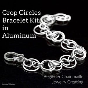 May include: A silver chainmaille bracelet kit in aluminium. The bracelet has a series of interconnected circular links and a hook clasp. Text on the image reads "Crop Circles Bracelet Kit in Aluminum" and "Beginner Chainmaille Jewelry Creating."