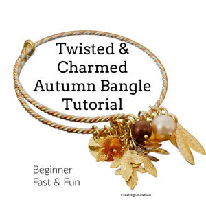 May include: A gold-toned twisted wire bangle bracelet with autumn-themed charms, including leaves, beads, and a small disc. The bracelet is labeled "Twisted & Charmed Autumn Bangle Tutorial" and "Beginner Fast & Fun".