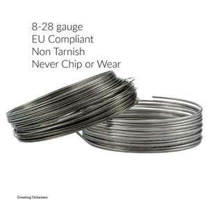 May include: Two coils of silver-colored metal wire. Text above reads: 8-28 gauge, EU Compliant, Non Tarnish, Never Chip or Wear. Text at the bottom reads: Creating Unkamen. The wire is wound into circular shapes with a metallic, reflective finish.