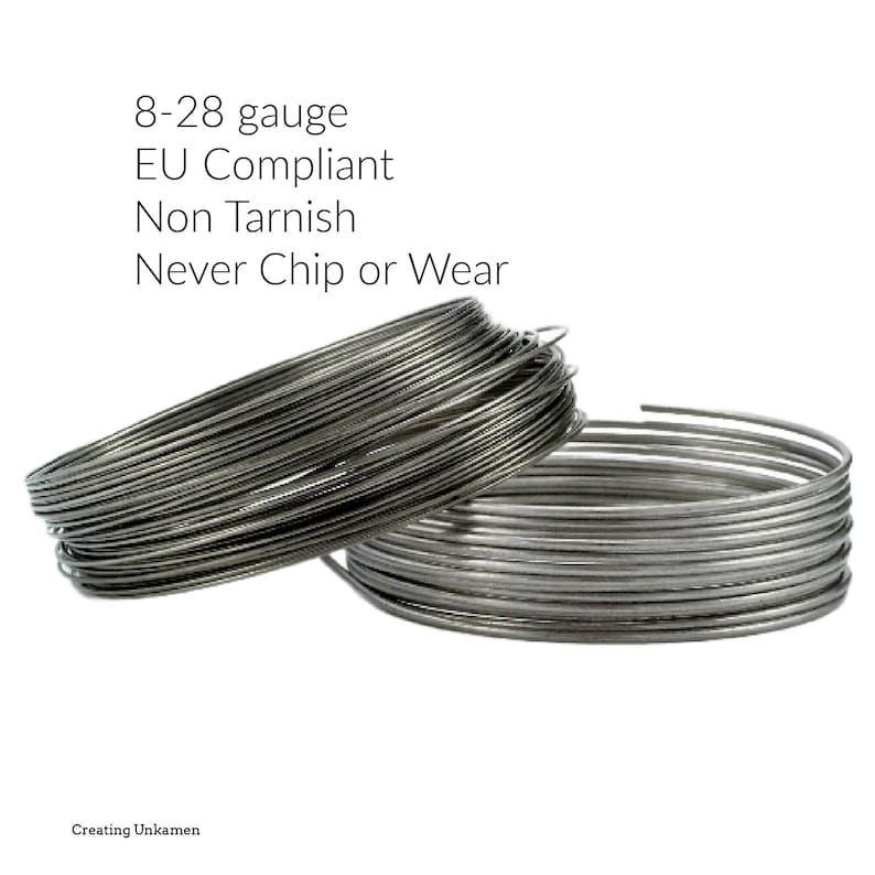 May include: Two coils of silver-colored metal wire. Text above reads: 8-28 gauge, EU Compliant, Non Tarnish, Never Chip or Wear. Text at the bottom reads: Creating Unkamen. The wire is wound into circular shapes with a metallic, reflective finish.