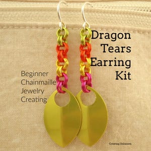 May include: A pair of drop earrings featuring a chainmaille design with lime green, orange, yellow, and magenta jump rings, ending in a gold-toned leaf-shaped charm. The text reads: Dragon Tears Earring Kit, Beginner Chainmaille Jewelry Creating.