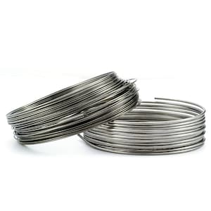 May include: Two circular coils of thin, silver-colored metal wire. Each coil consists of multiple continuous loops of wire wound tightly together, creating a layered, cylindrical shape with a smooth, reflective metallic finish and uniform thickness.
