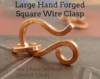 May include: A large hand forged square wire clasp made of copper-toned metal. The clasp features an S-shaped hook and a circular ring component. Text on the image reads: Large Hand Forged Square Wire Clasp, Your Choice of Metals, 20mm X 15mm, Made for YOU.
