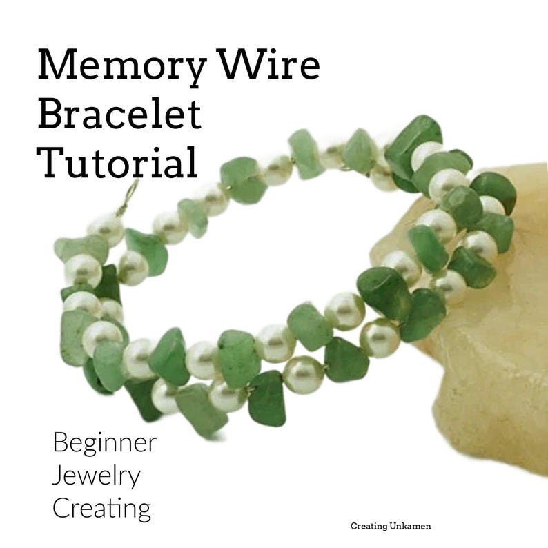 May include: A green and white memory wire bracelet with green stone beads and white pearl beads. The bracelet is on a light brown surface. Memory Wire Bracelet Tutorial.