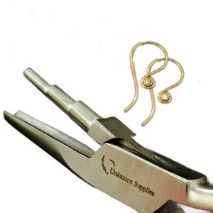 May include: Close-up of a pair of silver jewellery pliers with a gold earring hook in the jaws. The pliers are labelled "Unkamen Supplies".