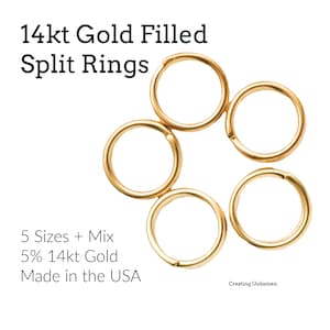 May include: Five gold-coloured split rings arranged in a circular pattern against a white background. The text "14kt Gold Filled Split Rings" is at the top. Additional text includes "5 Sizes + Mix", "5% 14kt Gold", and "Made in the USA".