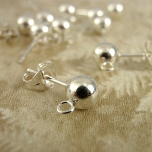 May include: Silver earring findings with a round ball and a loop for attaching a charm or pendant.